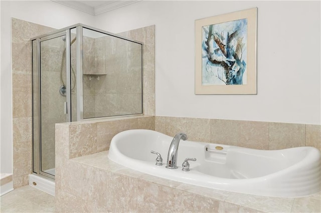 bathroom featuring a shower stall, a garden tub, and crown molding