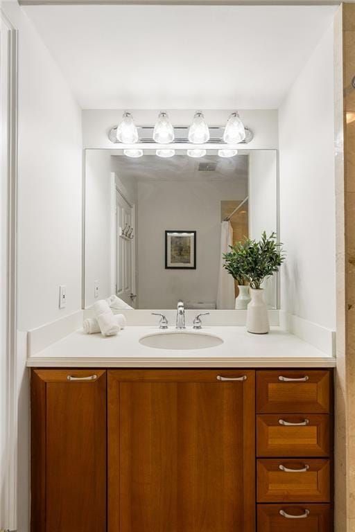 full bath with vanity and a shower with shower curtain