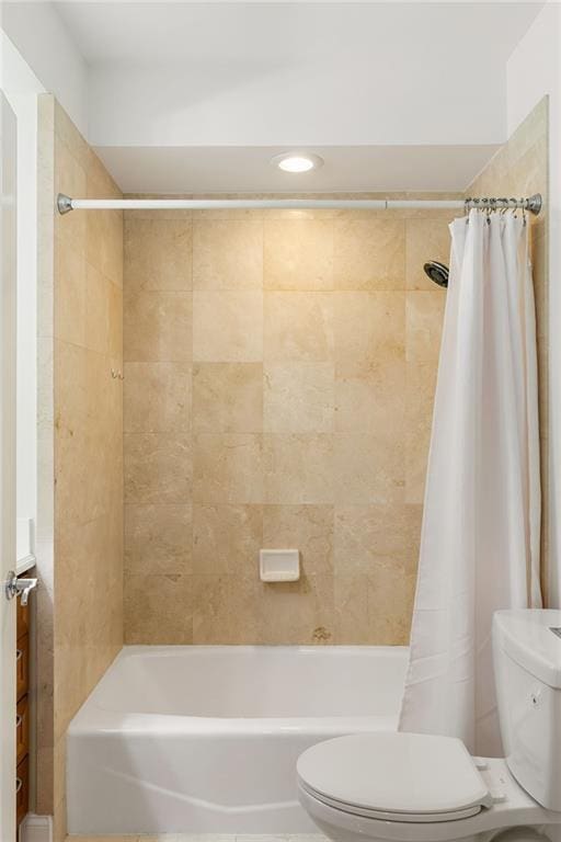 full bath with shower / bath combo with shower curtain and toilet