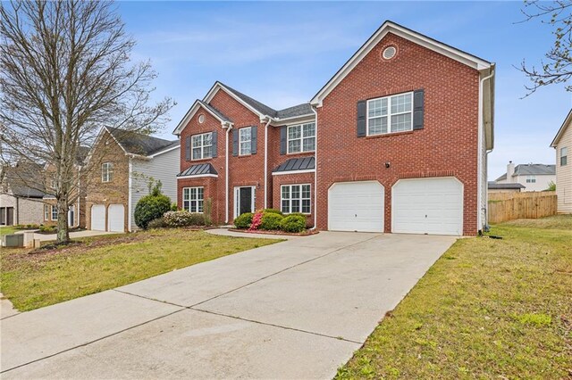 view of front of property with a front yard and a garage