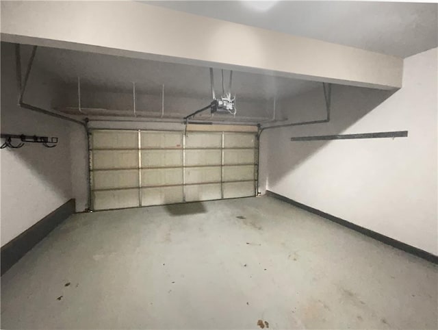 garage with a garage door opener and baseboards