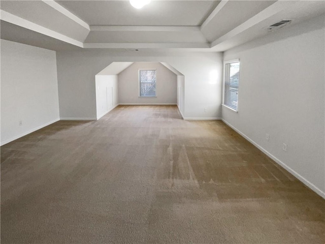 bonus room featuring a wealth of natural light, visible vents, and carpet