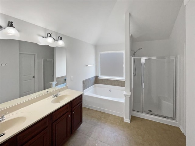 bathroom with a shower stall, a garden tub, and a sink