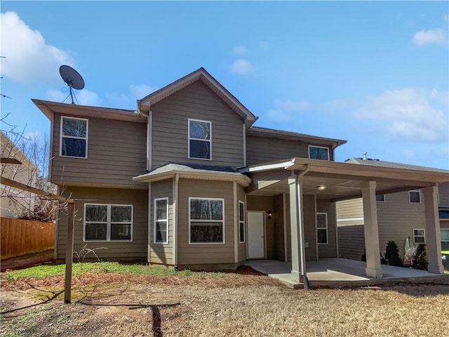 rear view of house featuring a patio area and fence