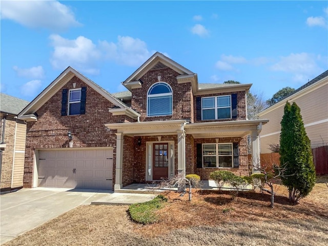 traditional home featuring brick siding, driveway, a porch, and a garage