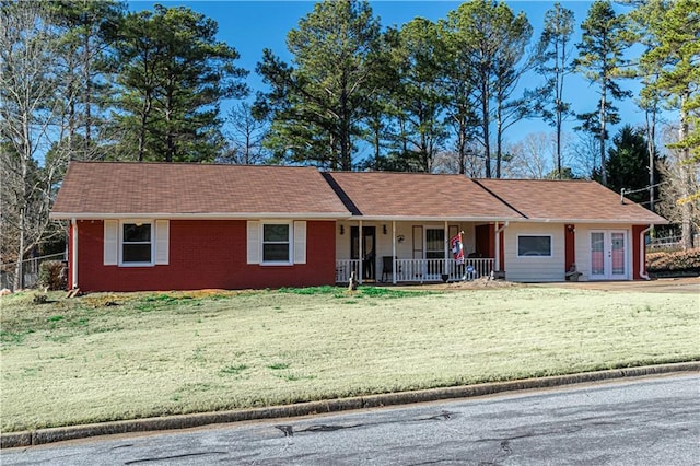 ranch-style home with french doors, a front lawn, and a porch