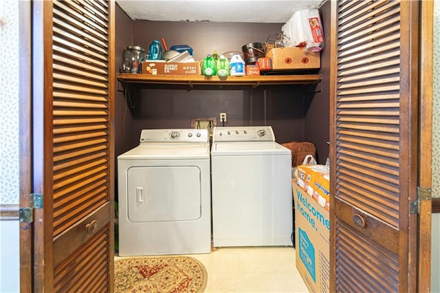 laundry area featuring washing machine and dryer and a textured ceiling