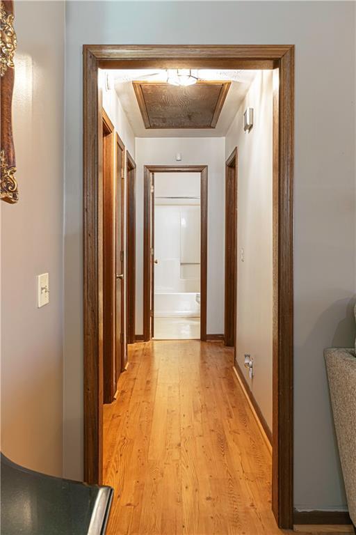 hallway with light hardwood / wood-style floors