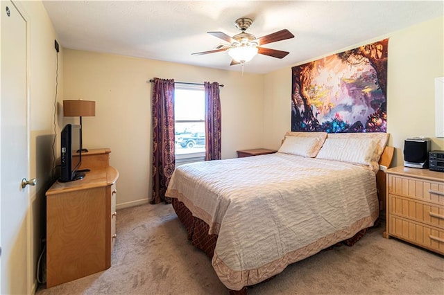 bedroom with ceiling fan and light colored carpet