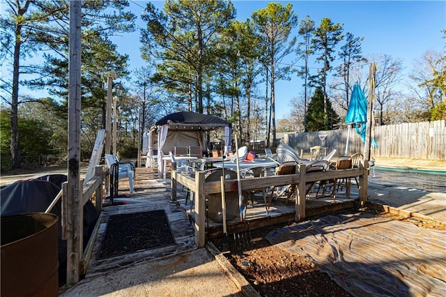 dock area with a gazebo and a pool