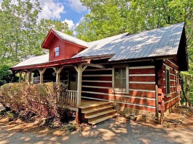 view of front of property featuring covered porch and metal roof