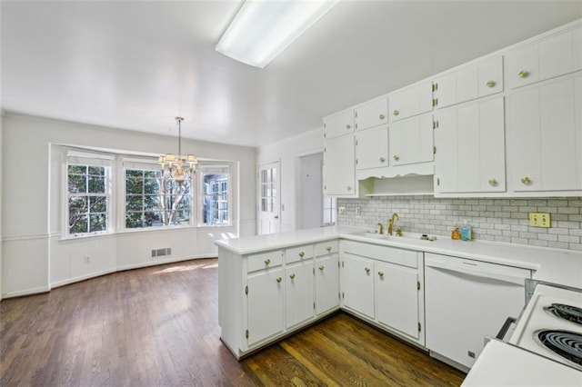 kitchen featuring pendant lighting, sink, dark wood-type flooring, white cabinetry, and backsplash