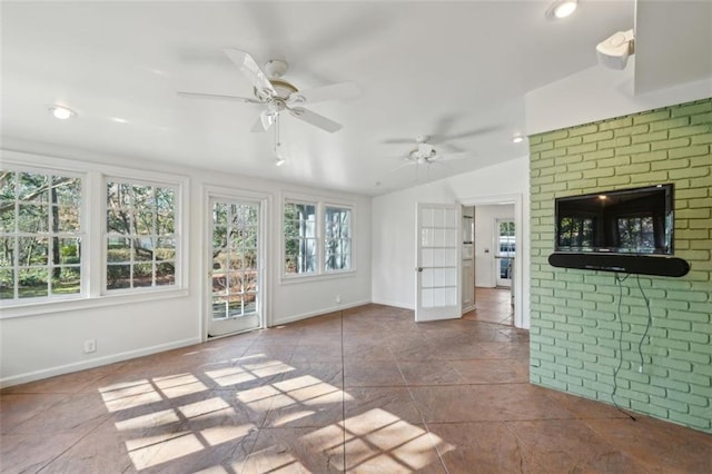 unfurnished living room with vaulted ceiling and ceiling fan