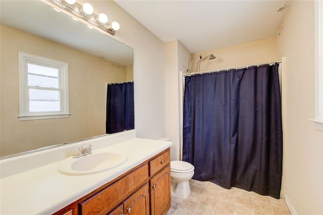 bathroom featuring walk in shower, vanity, and toilet