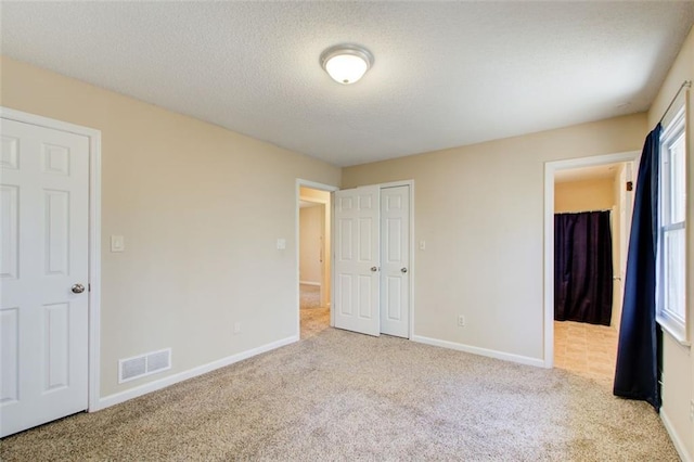 unfurnished bedroom featuring light colored carpet