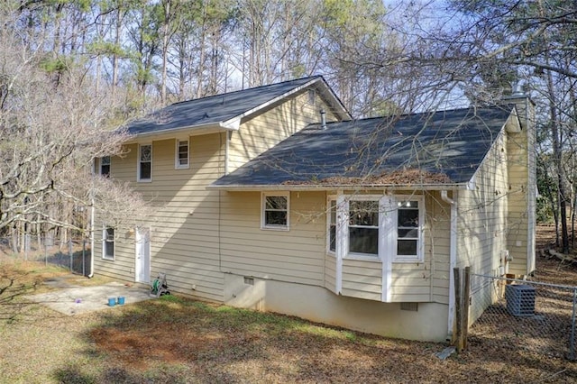 rear view of property featuring a patio and central air condition unit