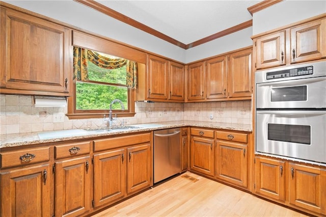 3436 Laurelwood Ct NE, Roswell, GA 30075 - kitchen with stainless steel appliances, brown cabinetry, light wood-style flooring, crown molding, and tasteful backsplash