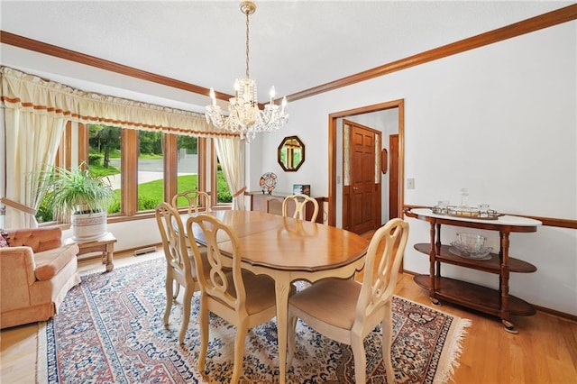 3436 Laurelwood Ct NE, Roswell, GA 30075 - dining space featuring a chandelier, ornamental molding, and light wood-style floors