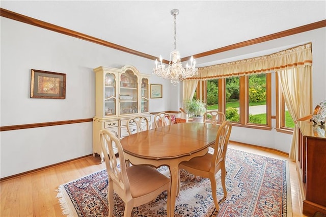 3436 Laurelwood Ct NE, Roswell, GA 30075 - dining space with a chandelier, crown molding, and light wood-style flooring