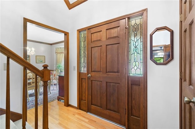 3436 Laurelwood Ct NE, Roswell, GA 30075 - entrance foyer featuring ornamental molding, light wood finished floors, stairs, and a chandelier