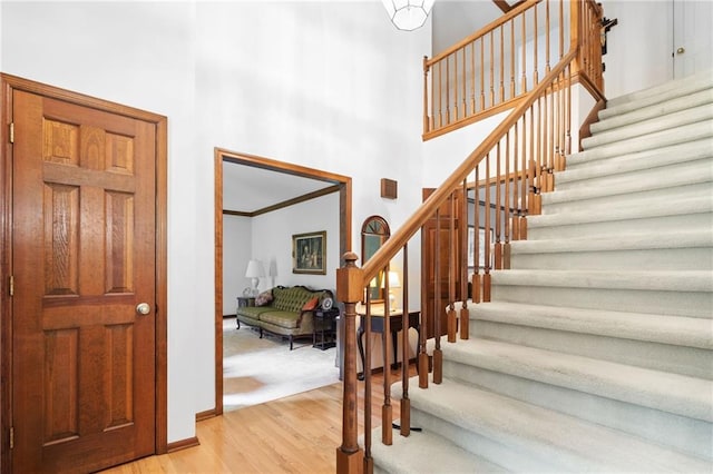 3436 Laurelwood Ct NE, Roswell, GA 30075 - stairway featuring a towering ceiling and wood finished floors