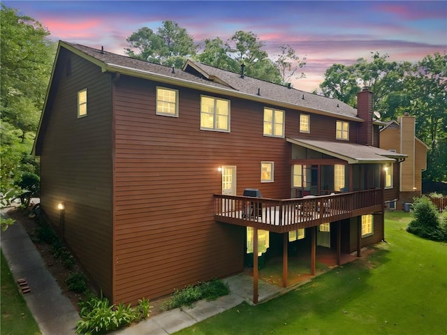3436 Laurelwood Ct NE, Roswell, GA 30075 - back of property at dusk featuring a deck, a lawn, and a chimney