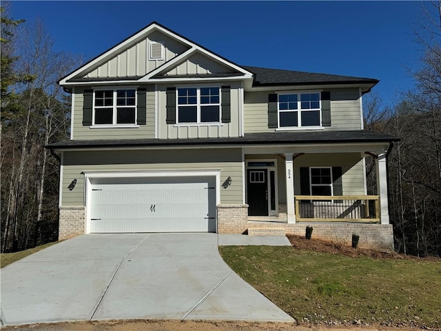 craftsman house with a porch, a garage, and a front yard