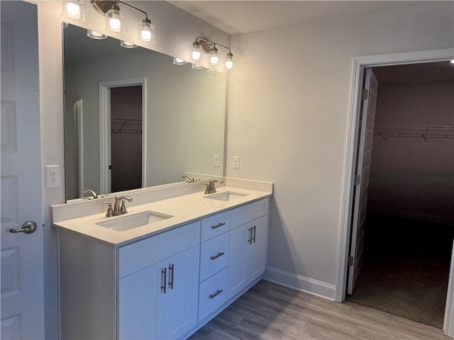 bathroom with hardwood / wood-style floors and vanity