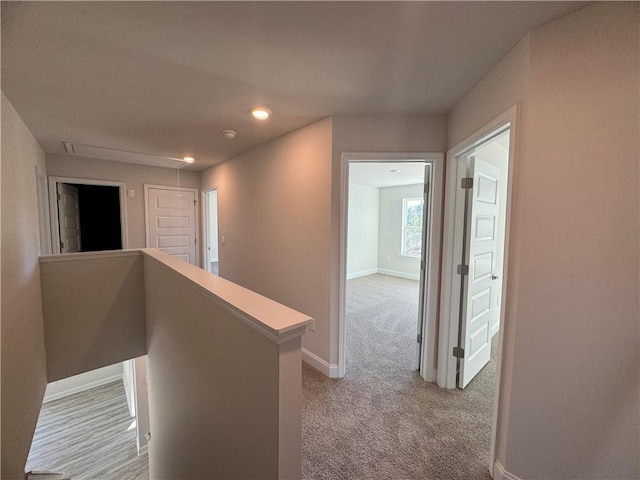 hallway featuring light carpet