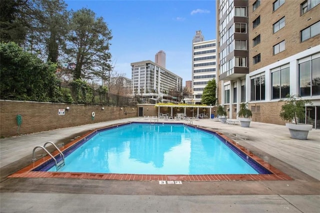 pool with a patio and a city view