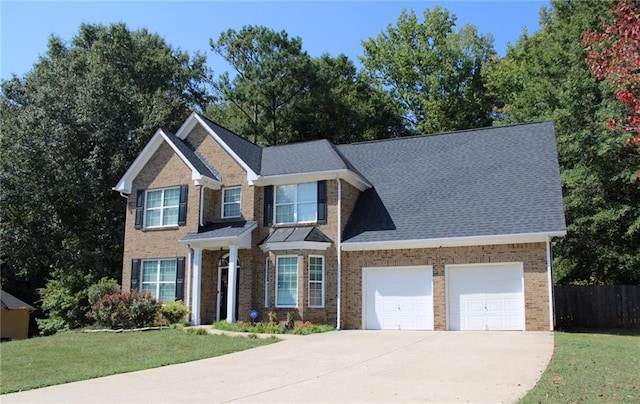 view of front of property featuring a front yard and a garage