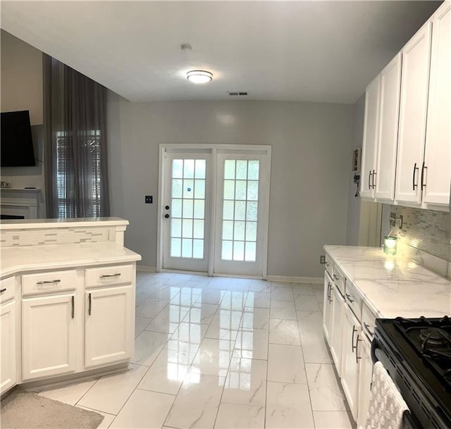 kitchen with white cabinets and backsplash