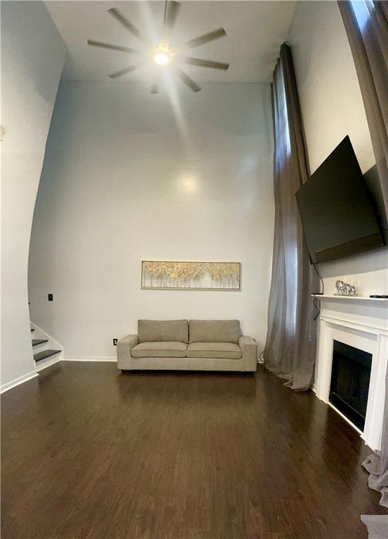 unfurnished living room with dark wood-type flooring