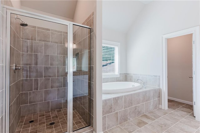 full bath featuring a stall shower, tile patterned flooring, a garden tub, and vaulted ceiling