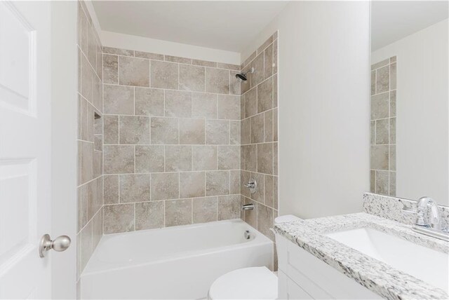 bathroom featuring vanity, toilet, and bathtub / shower combination