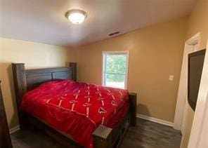 615 Woodruff Rd, Carrollton, GA 30116 - bedroom with baseboards, visible vents, wood finished floors, and vaulted ceiling