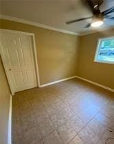 615 Woodruff Rd, Carrollton, GA 30116 - unfurnished bedroom featuring baseboards, ornamental molding, and a ceiling fan