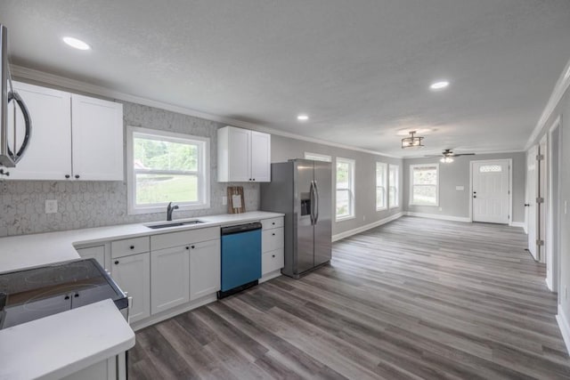 kitchen featuring dishwashing machine, a sink, crown molding, stainless steel refrigerator with ice dispenser, and recessed lighting