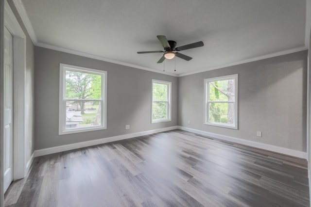unfurnished room featuring crown molding, baseboards, wood finished floors, and ceiling fan