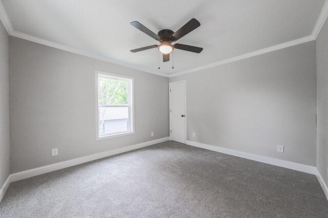 unfurnished room featuring ornamental molding, carpet flooring, baseboards, and a ceiling fan