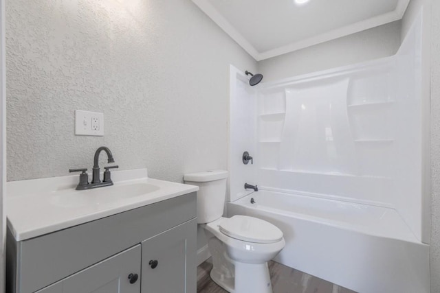 bathroom featuring wood finished floors, toilet, a textured wall, vanity, and shower / tub combination