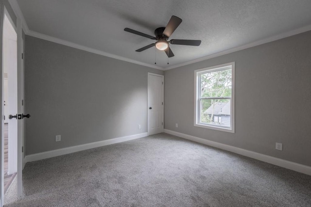 unfurnished room featuring crown molding, carpet flooring, baseboards, a ceiling fan, and a textured ceiling