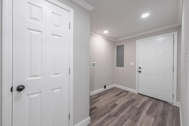 washroom with electric panel, ornamental molding, baseboards, wood finished floors, and hookup for a washing machine