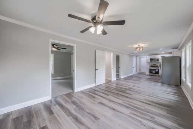 unfurnished living room with ornamental molding, a ceiling fan, baseboards, and light wood-type flooring