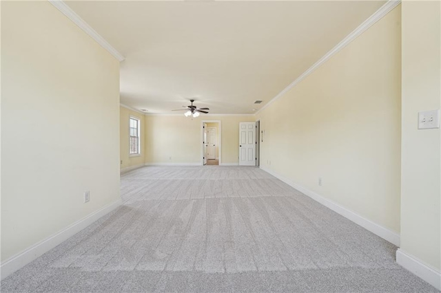 unfurnished room with baseboards, light colored carpet, ornamental molding, and ceiling fan