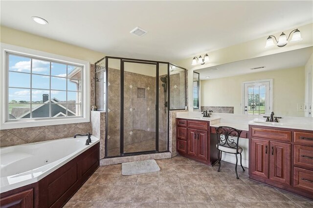 full bath featuring a stall shower, a jetted tub, vanity, and visible vents