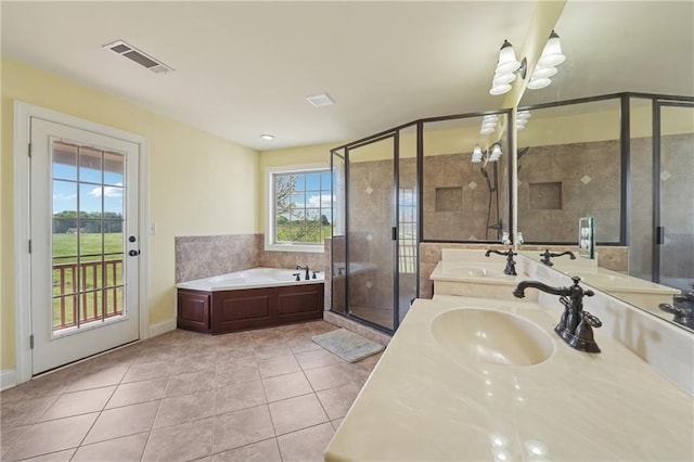 bathroom with a sink, visible vents, tile patterned floors, and a shower stall