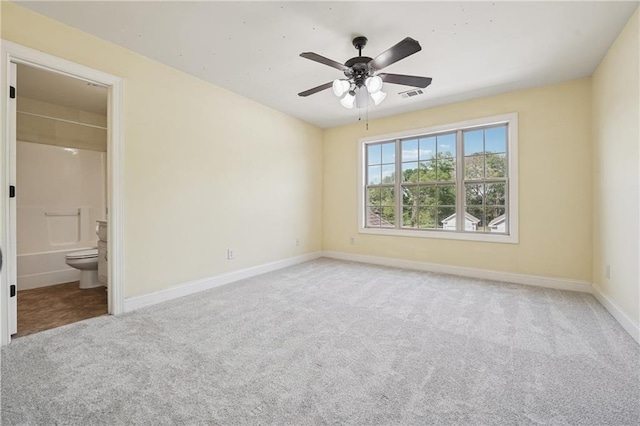 unfurnished bedroom featuring visible vents, baseboards, carpet flooring, and ensuite bathroom