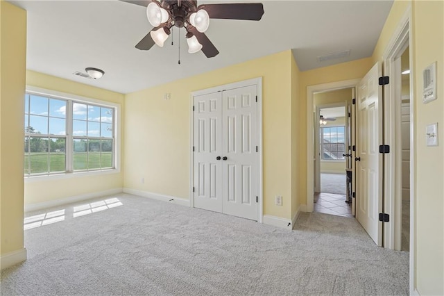 unfurnished bedroom featuring visible vents, baseboards, and carpet floors