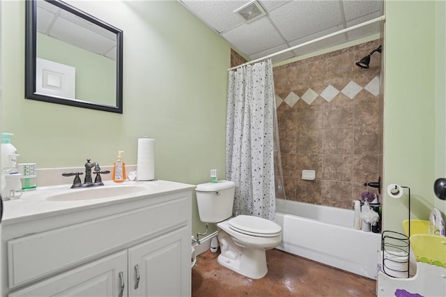 bathroom with vanity, finished concrete flooring, toilet, visible vents, and a drop ceiling